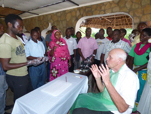 Professor Cooper addressing a crowd of people sat at a table