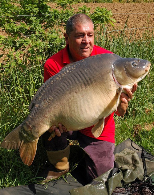 Photo of Ken Townley holding a carp