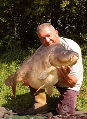 Image of Ken Townley holding a very large carp