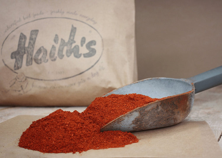 Deep orange colour food in front of a Haith's brown bag.