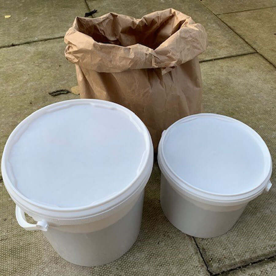 Two plastic storage tubs and a bag of Haith's SuperClean bird seed.