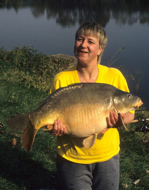 Image of a lady holding a large carp