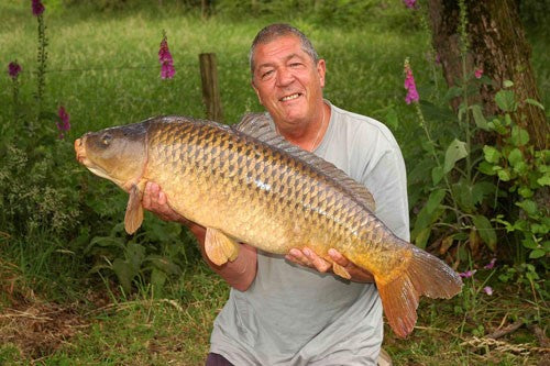 Photo of Ken Townley holding a large carp