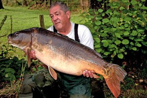 Photo of Ken Townley holding a large carp 