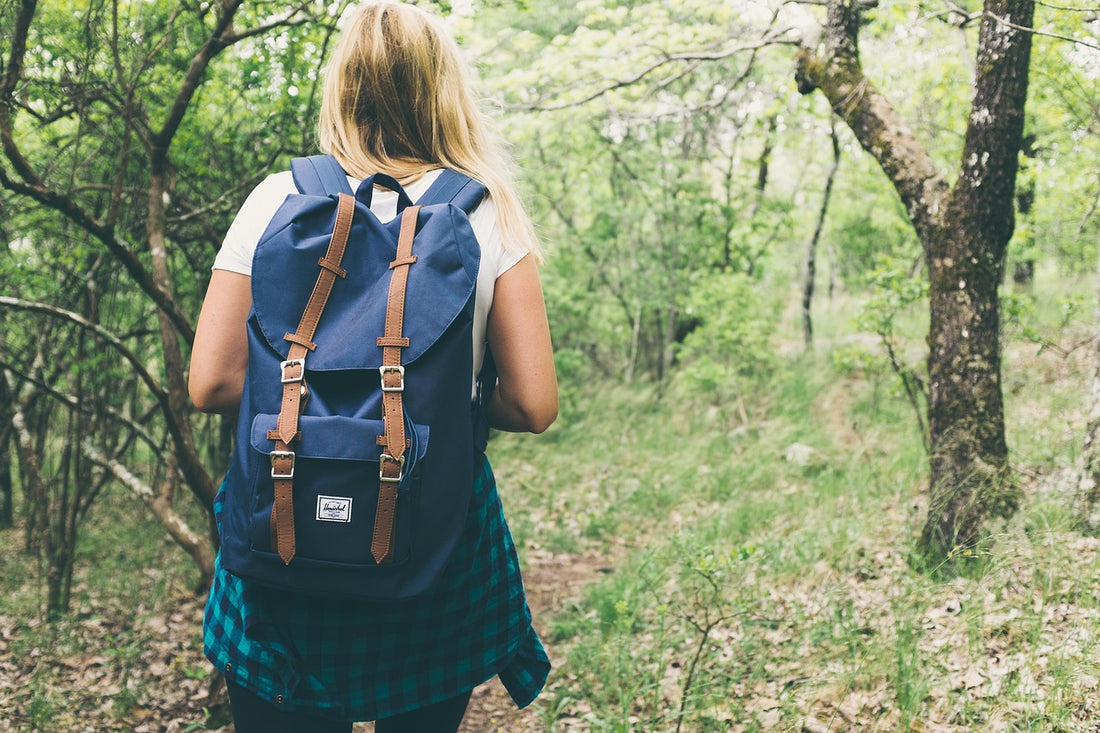 a young female backpacker in the forest