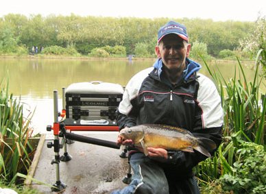 Steve Scott holding a mirror carp that he caught