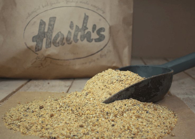 Crumbly fishing bait in front of a Haith's paper bag. 