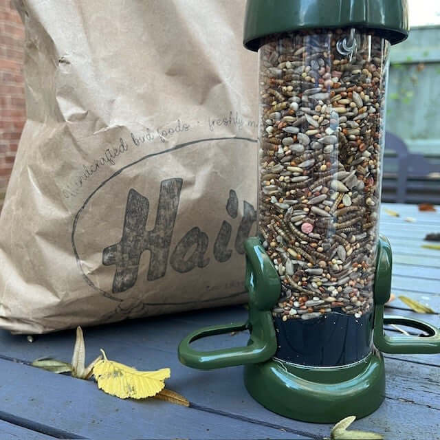 Wild bird food in bird feeder and Haith's bag. 