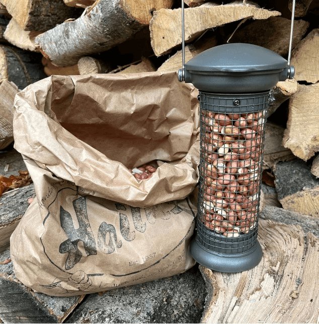 Full peanut feeder and bag of nuts. 