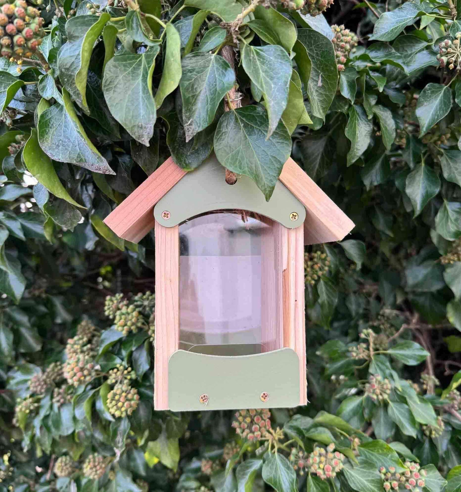 Sage green bird seed feeder made from FSC certified timber  with pitched roof.