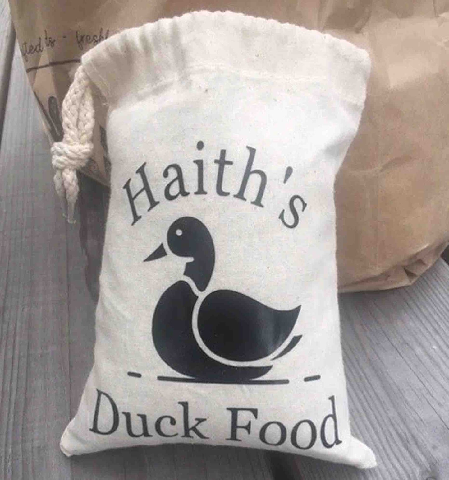 Haith's Duck Food Pouch, showcasing it's drawstring and black duck printed on the front. 