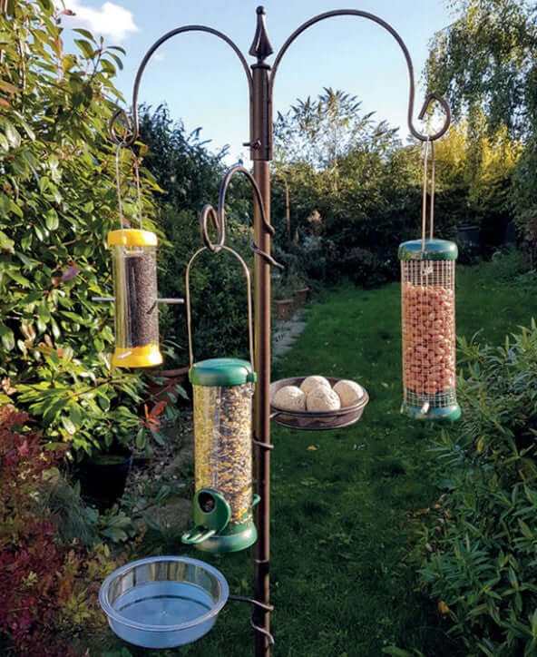 Full bird feeding station with feeders, a water bowl and fat ball holder. 