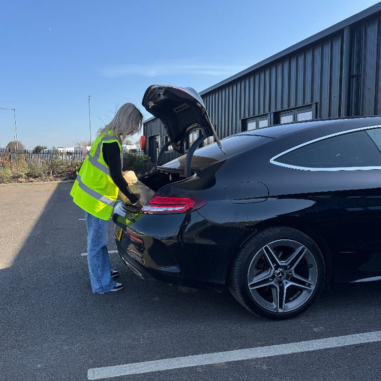 A Haith's customer loading bird food into a vehicle