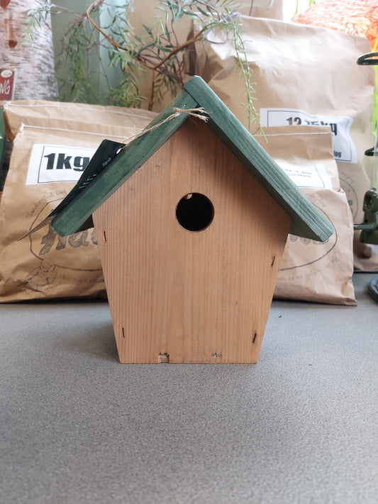 A sturdy, hand-crafted nest box with a dark green roof. 