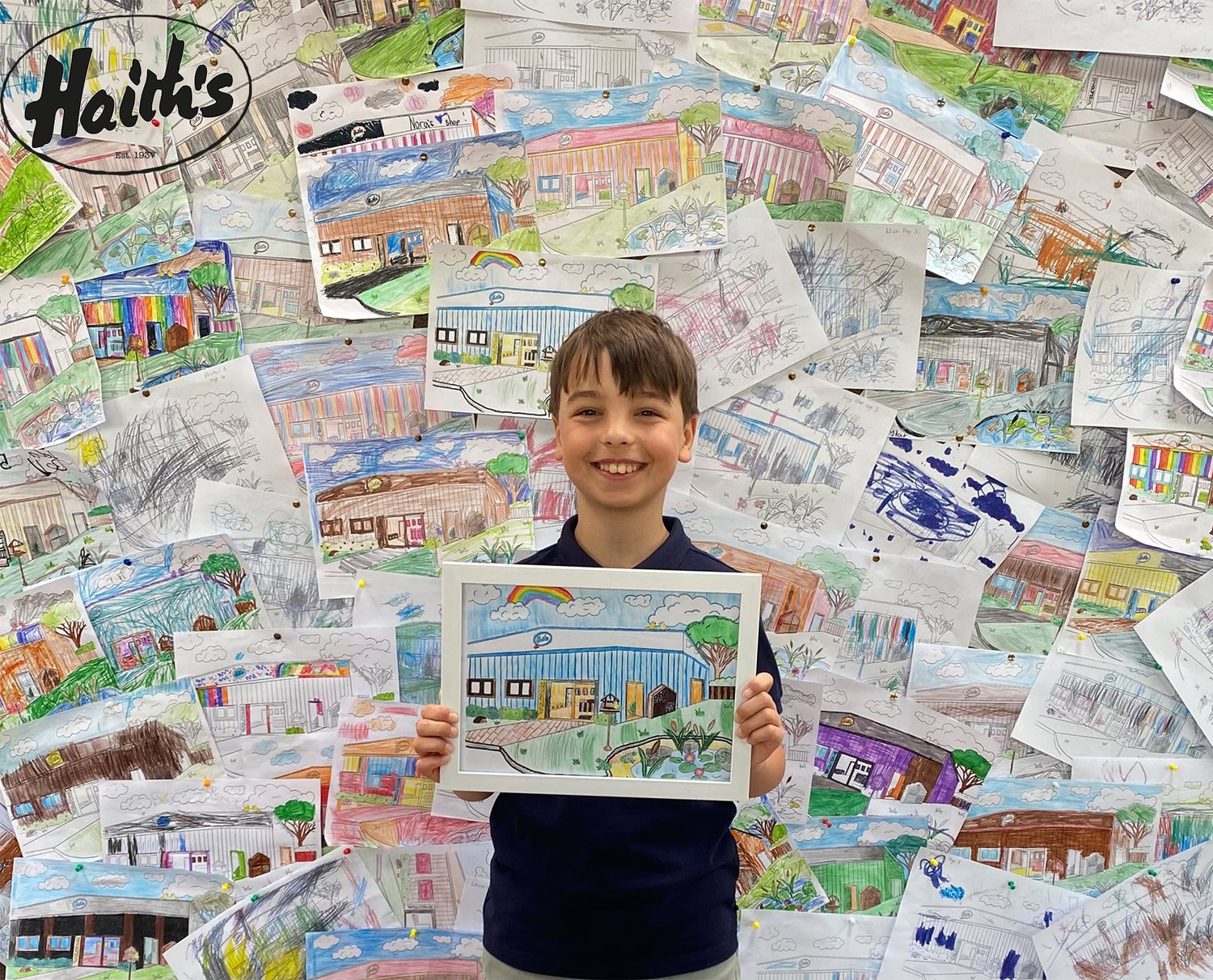 Boy holding his winning colouring page at Haith's. 