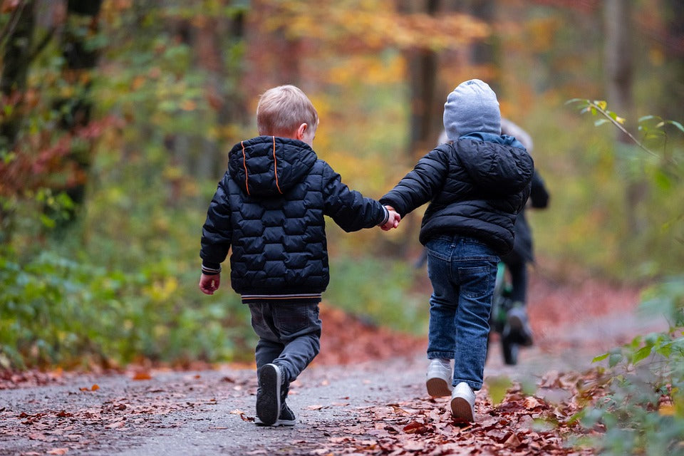 children running through forest