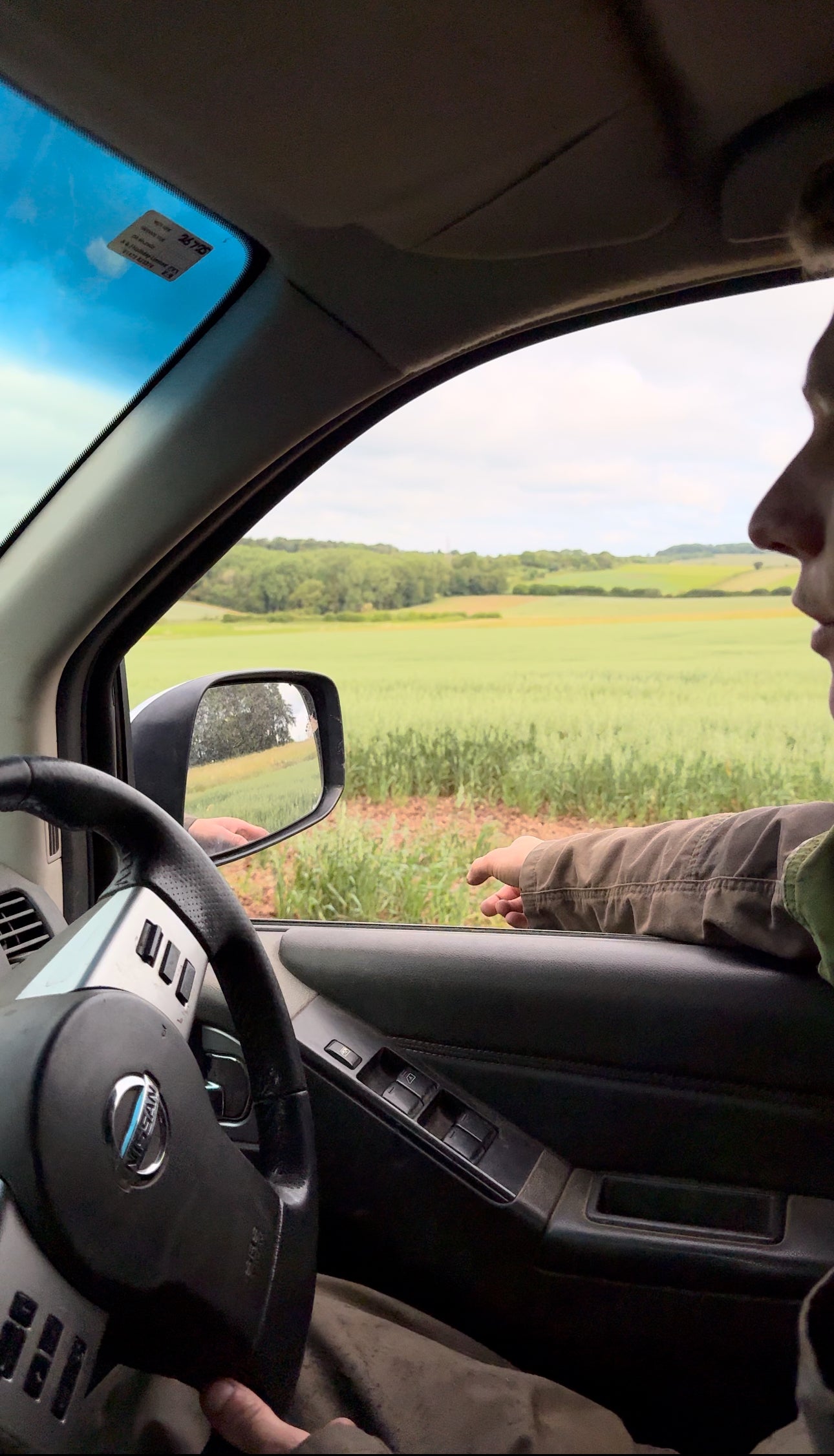 of farmer looking at fields of wheat