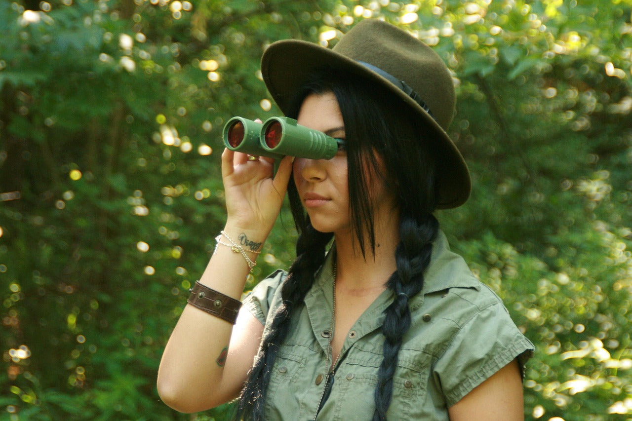 girl birdwatching win binoculars