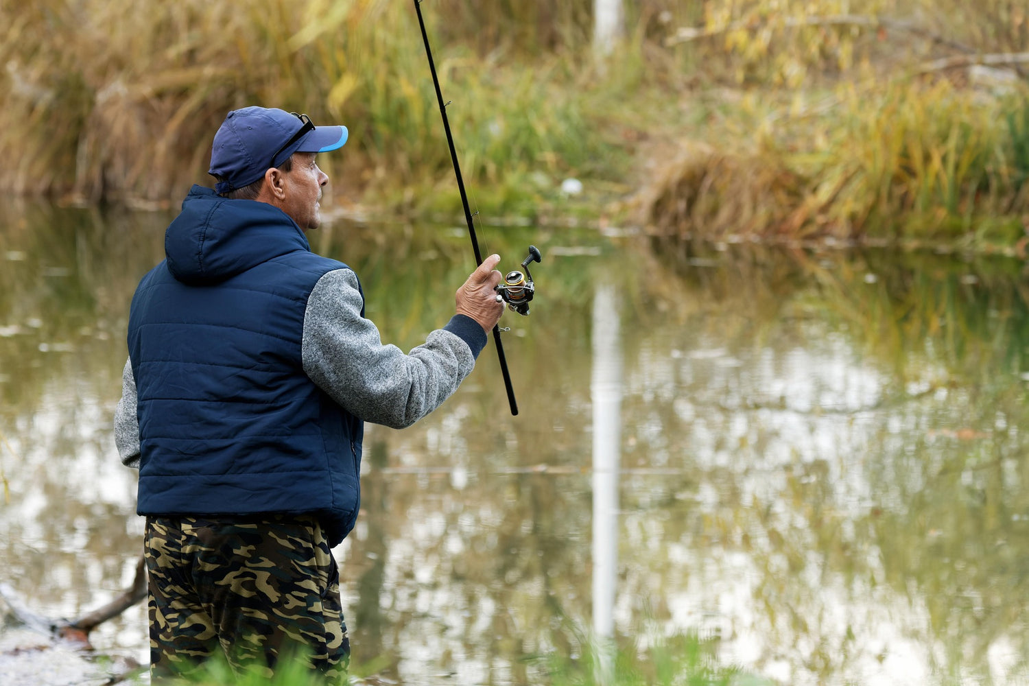 man fishing on lakeside