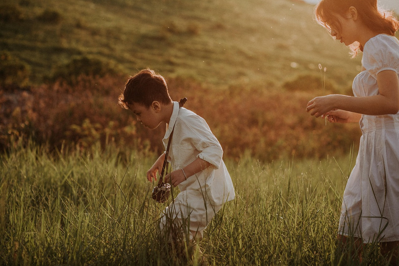 mother and child in field with camera