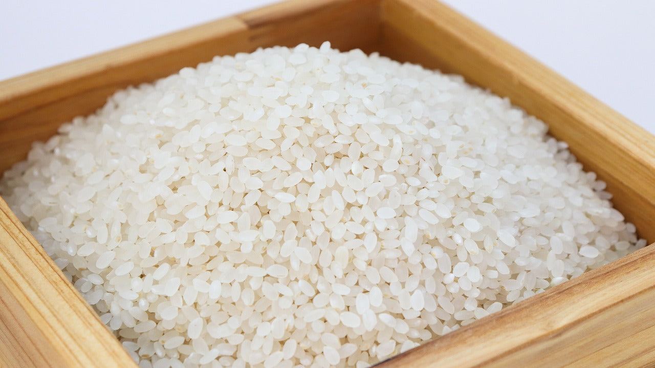 cooked white rice in a brown dish