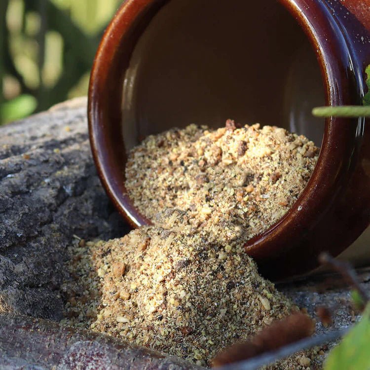 Softbill Food™ being poured from a brown pot