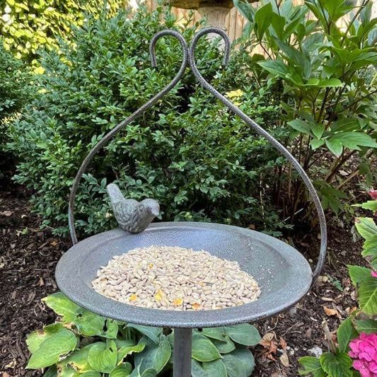 Metal feeding dish with decorative bird and ornamental features, strong and stable.