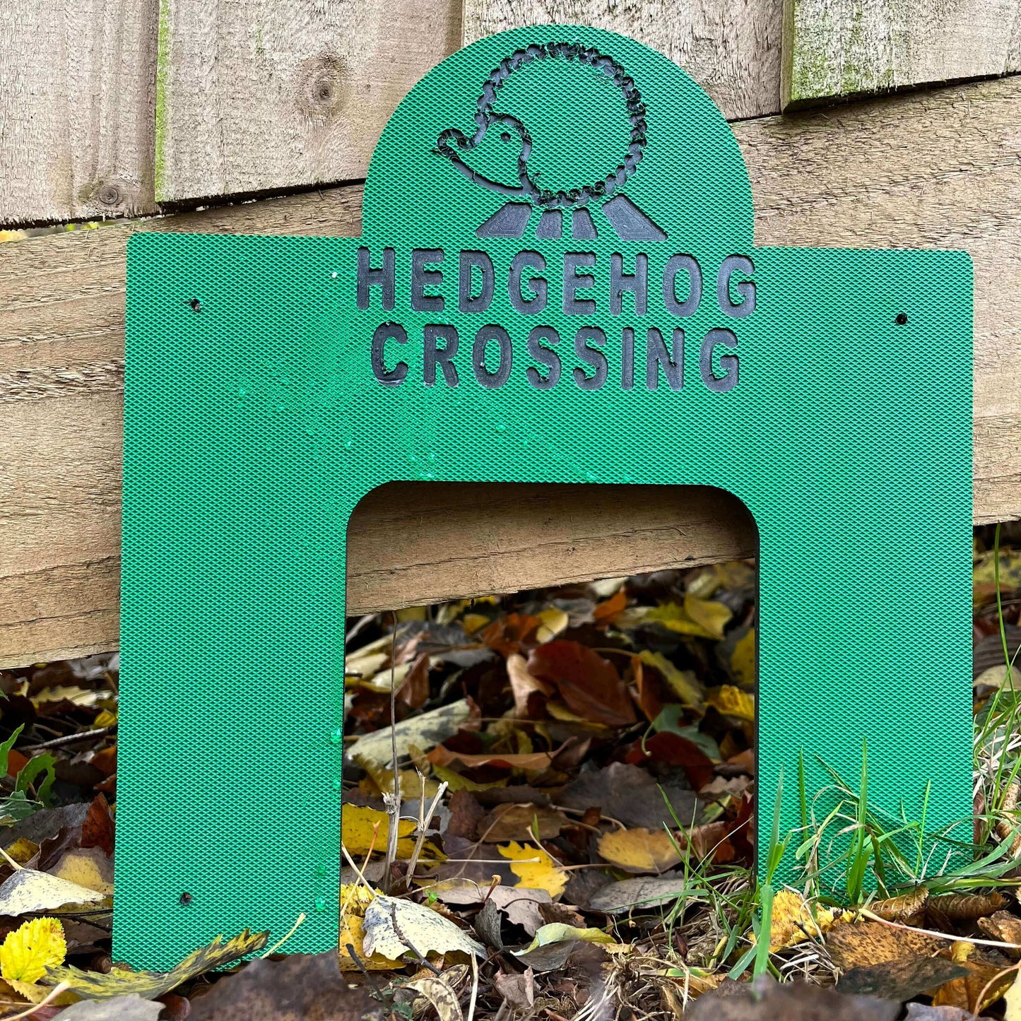 Haith's green Hedgehog Crossing lent up against a fence. 