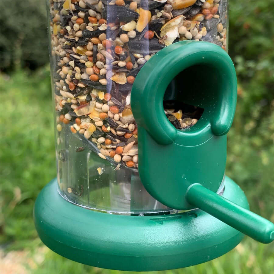 Easy to clean seed feeder with green plastic top, bottom and ports