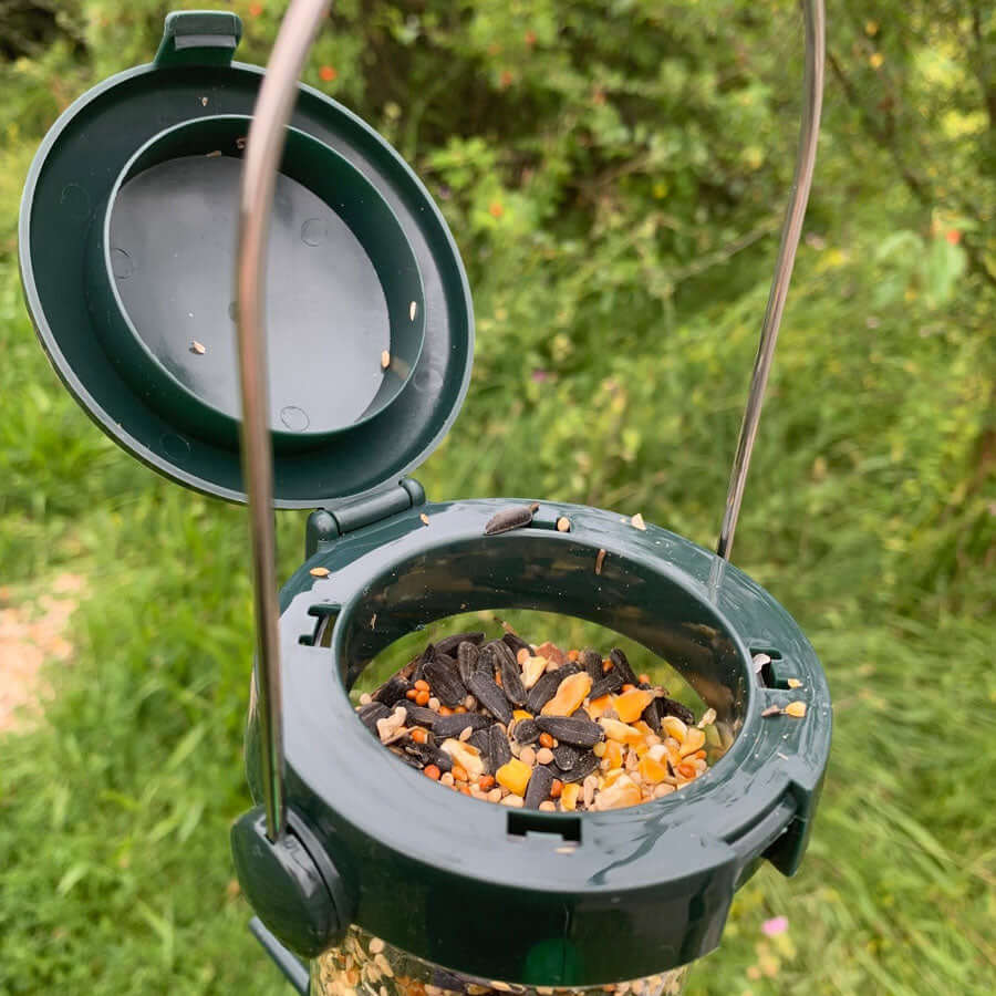 Seed feeder with flick top which is hinged to open easily. 