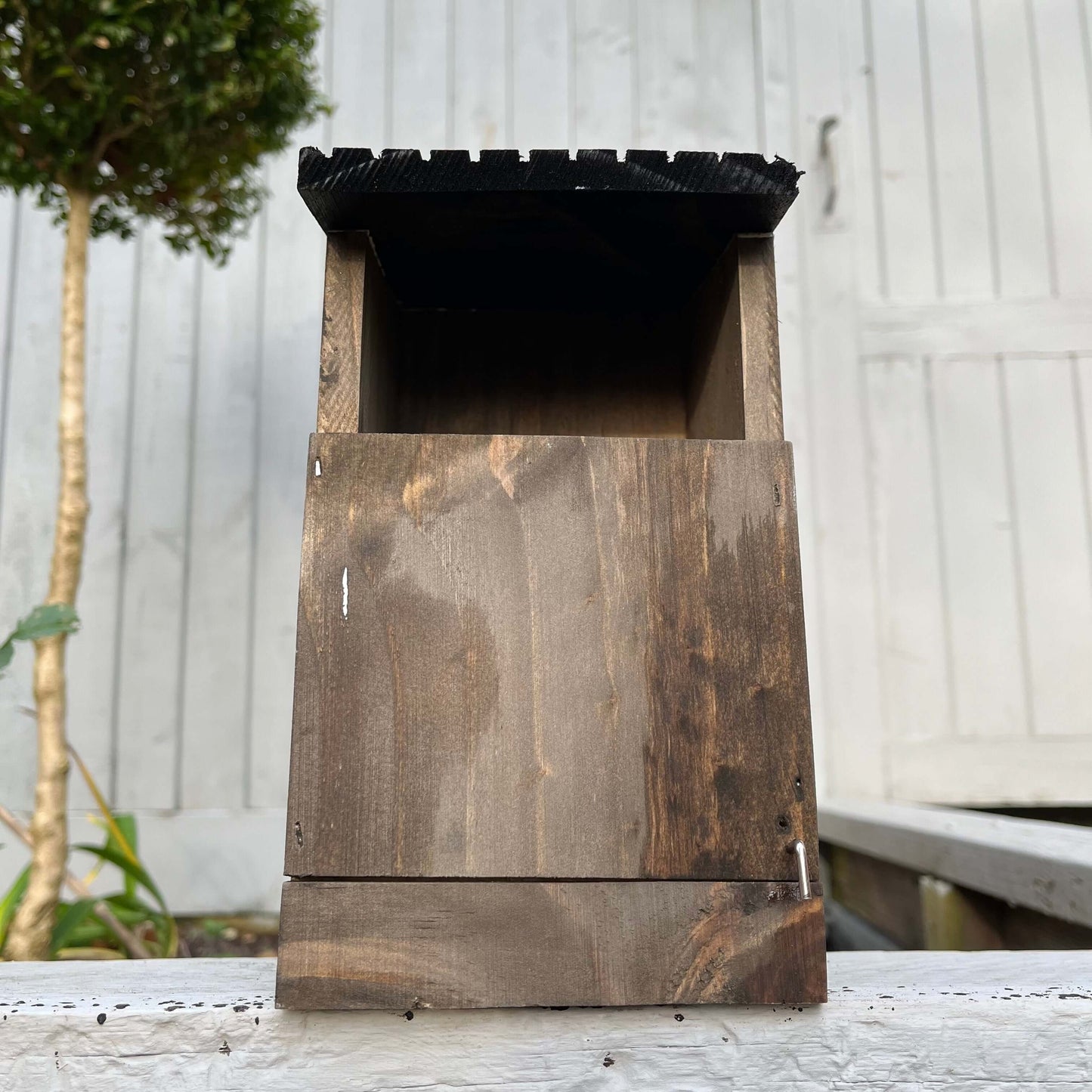 Dark oak-stained front of the nest box.